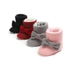 Display of winter baby boots in four colors showing the fleece lining and bow details