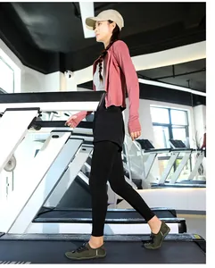 Asian woman wearing green quick-dry barefoot shoes while walking on a gym treadmill