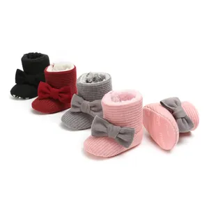 Selection of cozy fleece-lined baby snow boots with bows in various pastel colors
