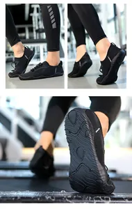 Detailed view of black quick-dry water shoes featuring anti-slip wavy rubber soles.