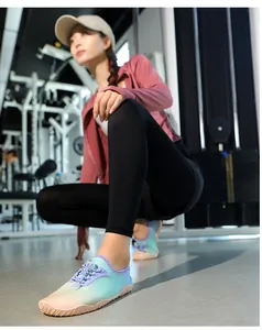 Detailed view of quick-dry aqua shoes with gradient color and non-slip sole in a gym setting.