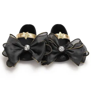Elegant black baby girl princess shoes with large mesh bow and golden star detail