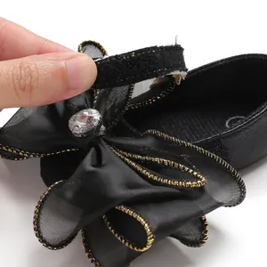 Detailed close-up showing the Velcro closure on black baby girl princess toddler shoes