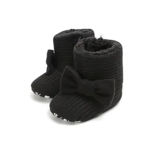 Warm black ribbed baby snow boots with bow decoration and soft fur lining for winter