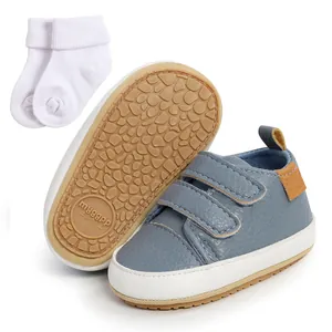 Blue baby walking sneakers with velcro straps and matching white socks detail