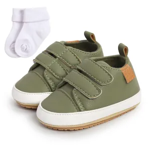 Detail view of olive green infant walking shoes with matching soft white baby socks set