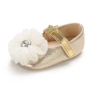 Detailed view of gold baby girl princess shoe with white tulle flower and star