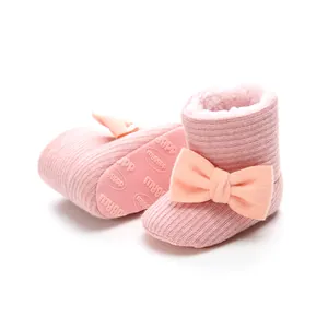 Warm pink fleece-lined baby snow boots with cute bow detail and non-slip sole.