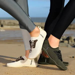 Durable non-slip quick-dry water shoes for men and women shown on a sandy beach background