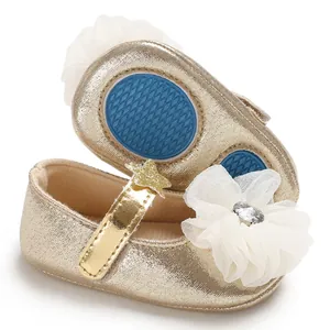 Detail of gold baby princess shoes with mesh flower and anti-slip blue rubber sole