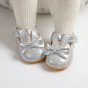 Detailed shot of silver glitter baby princess shoes with cute rabbit ears