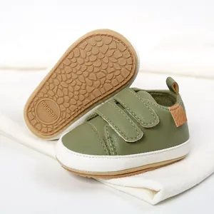 Detail showing the non-slip pebble textured sole and velcro straps of olive green baby shoes