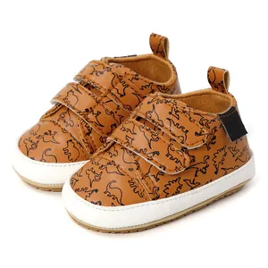 Brown baby walking shoes featuring dinosaur print and easy hook-and-loop straps