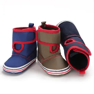 Detailed view of multi-color baby soft sole toddler boots featuring red trim accents.