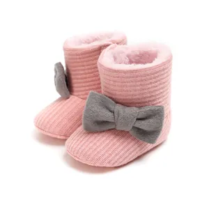 Cozy pink knitted baby snow boots with warm plush lining and stylish grey bows