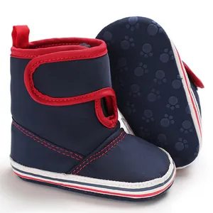 Detail view of navy blue baby walking boots with soft anti-slip rubber sole and paw print