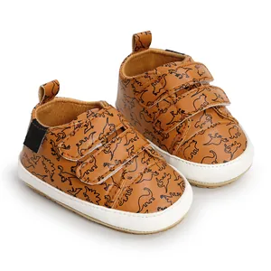 Detailed view of baby walking shoes with dinosaur prints and convenient velcro straps