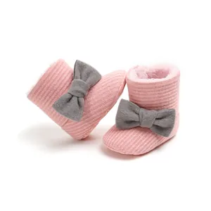 Premium soft pink knitted infant snow boots with warm plush lining and cute grey bow detail.