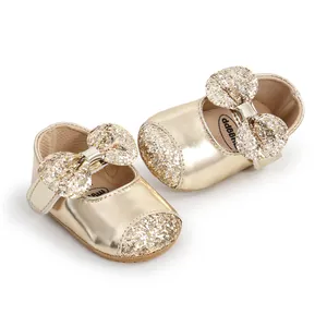 Close-up of golden sequin bow and sparkling toe on soft-sole baby princess shoes