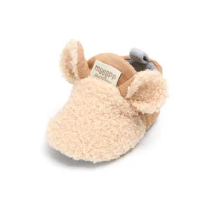 Close-up detail of winter cartoon baby cotton shoes with soft plush ears and warm lining