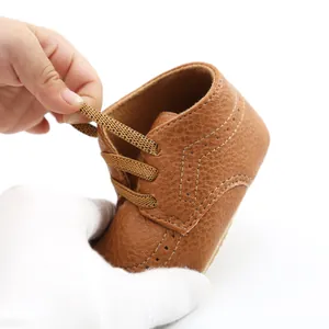 Close-up detail of brown PU leather baby soft sole walking shoes with laces