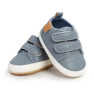 Detailed view of blue faux leather baby walking shoes featuring double velcro straps