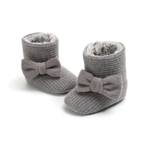 Close-up of grey fleece-lined baby winter boots with soft sole and bow detail