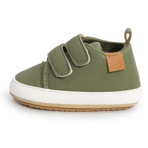 Side view of olive green baby walking shoes with velcro straps and white soles