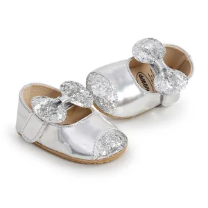 Detail view of silver baby princess shoes with glittery bow and non-slip soft sole