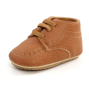 Detail view of a classic brown PU leather baby walking shoe with decorative stitching