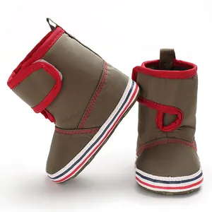 Side and front detail of baby soft-sole walking boots in olive green with red trim