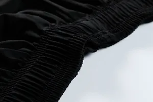 Detail showing the elastic waistband and stitching on black quick-dry sports shorts
