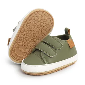 Detailed view of olive green baby walking shoes showing sole pattern and velcro straps