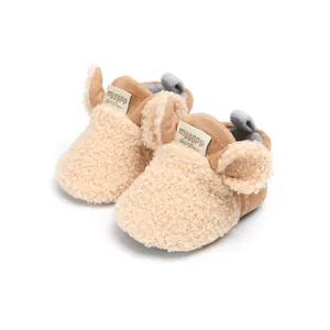 Close-up of brown fleece baby pre-walker shoes with cute ear details and velcro strap