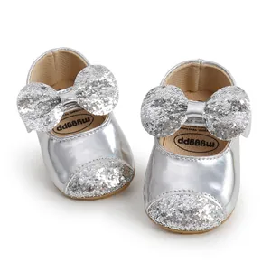Detailed macro shot of silver sequin baby princess shoes featuring a large glittery bow