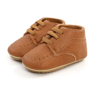 Close-up of brown PU leather baby walking shoes with soft soles and stitch details