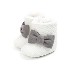 Close-up of baby winter snow boots with fleece lining and gray bow detail