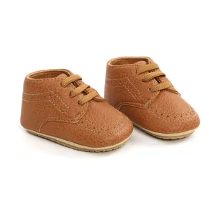 Detail view of brown PU leather baby walking shoes with soft soles and lace-up design