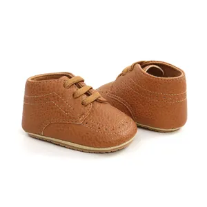 Detailed view of classic brown PU leather infant baby walking shoes with soft soles