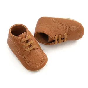 Detailed close-up view of brown PU leather baby walker shoes with decorative perforations
