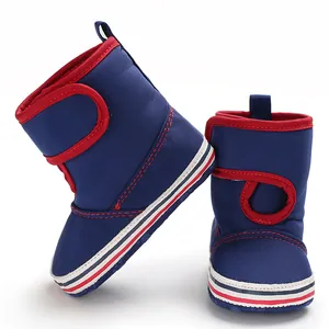 Detail view of blue infant toddler boots with red trim and velcro straps for warmth