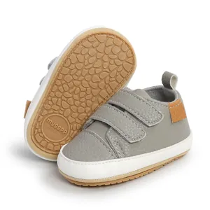 Grey faux leather baby walking shoes featuring non-slip rubber sole and secure velcro straps