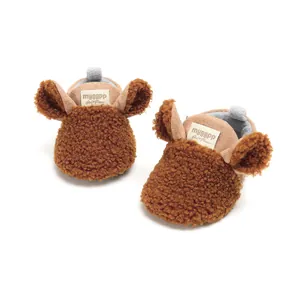 Detail view of cozy brown sherpa baby booties featuring cute animal ears and soft lining
