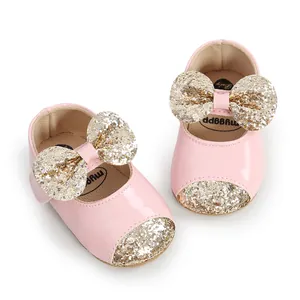 Pink baby girl princess walking shoes featuring gold glitter bow and sequin detail