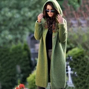 Cozy olive green long hooded knitted cardigan for women in a outdoor garden setting