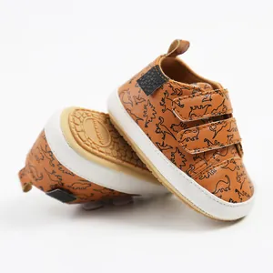 Detail view of brown baby walking shoes with dinosaur pattern and durable anti-slip sole.