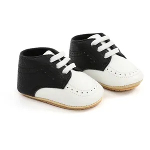 Macro detail of black and white soft sole baby walking shoes with white cotton laces