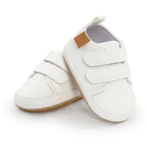 Close-up of comfortable white baby pre-walker sneakers featuring double velcro straps