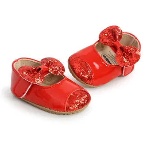 Detail view of red sequin bow baby princess shoes with soft soles and velcro strap.