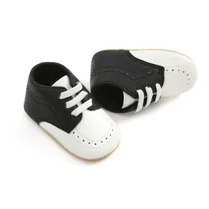 Detailed view of black and white soft sole baby walking shoes made of textured leather